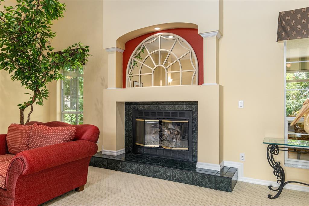 2215 Spring Hill Court Ocala, FL 34471 - Photo 9 of 62 a living room with furniture a fireplace and a potted plant