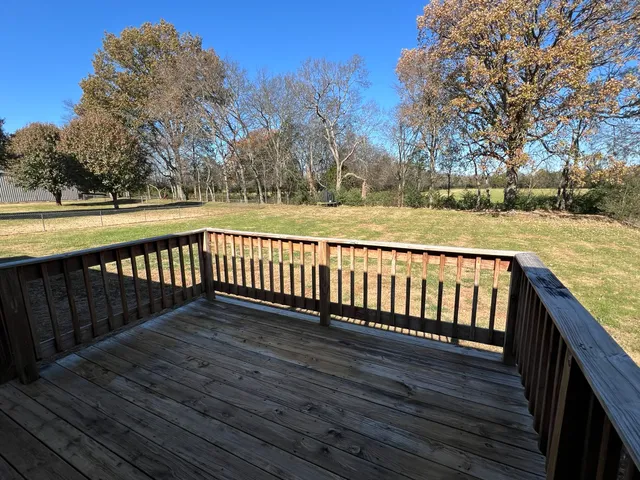 a view of deck with wooden floor and fence