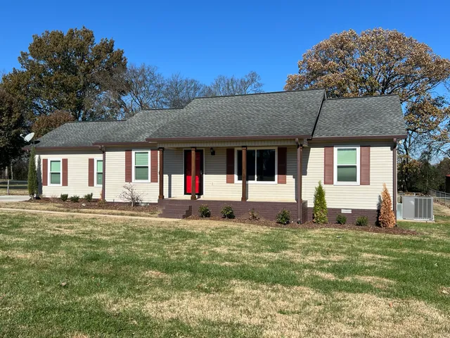 a front view of a house with a garden