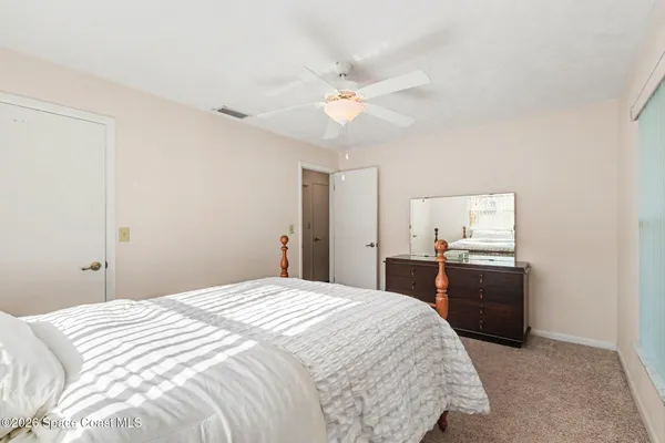 a bedroom with a bed and a dresser