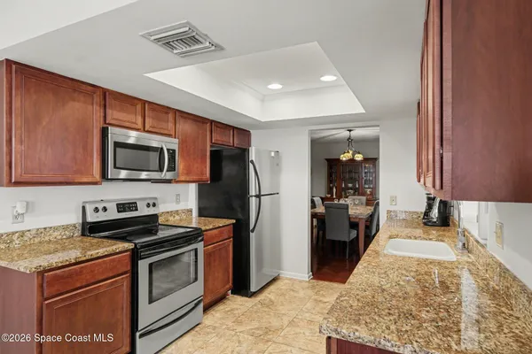 a kitchen with stainless steel appliances granite countertop a refrigerator stove and oven