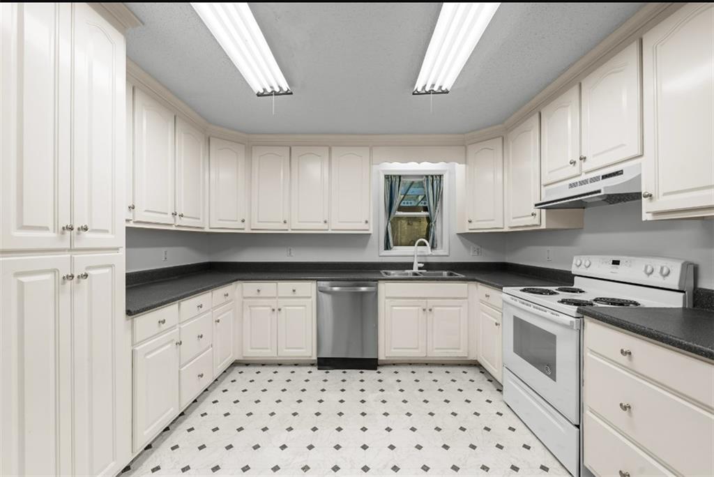 620 Wash Wilson Road Blue Ridge, GA 30513 - Photo 13 of 26 a kitchen with granite countertop white cabinets a sink a stove a window and dishwasher
