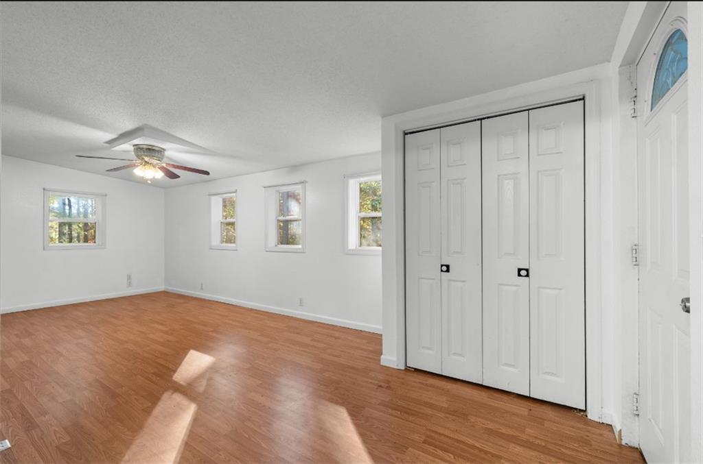 620 Wash Wilson Road Blue Ridge, GA 30513 - Photo 18 of 26 a view of an empty room with wooden floor and a window
