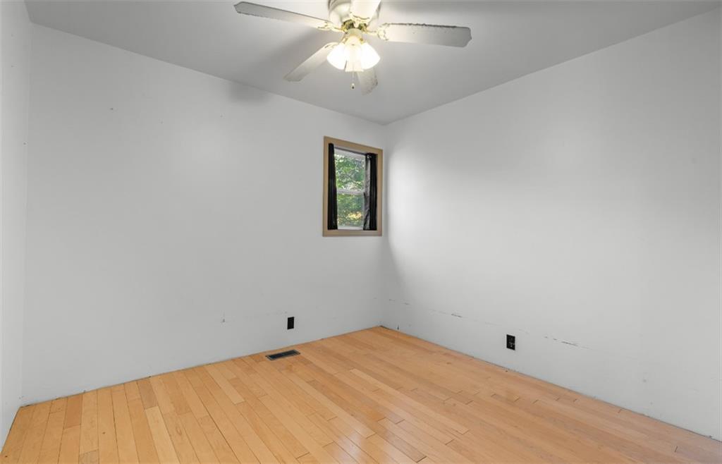 620 Wash Wilson Road Blue Ridge, GA 30513 - Photo 25 of 26 an empty room with a chandelier fan and windows