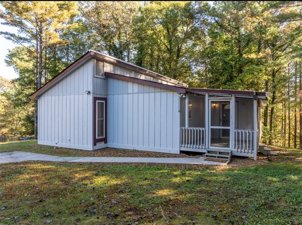 620 Wash Wilson Road Blue Ridge, GA 30513 - Photo 6 of 26 a view of a house with a backyard and tree