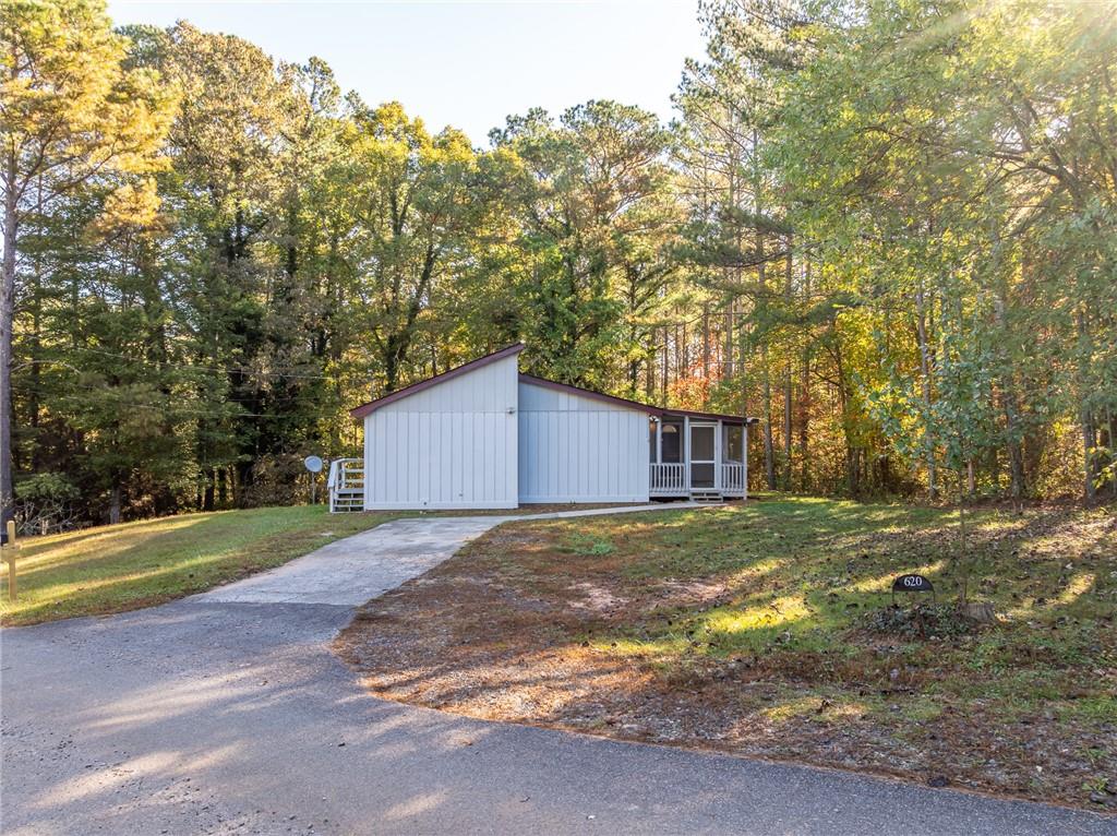 620 Wash Wilson Road Blue Ridge, GA 30513 - Photo 10 of 26 a view of a house with a yard and large trees