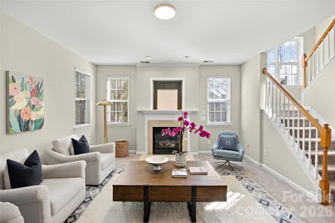 a living room with furniture and paintings on the wall