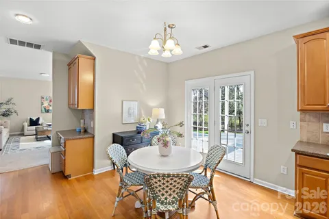 a view of a dining room with furniture and chandelier