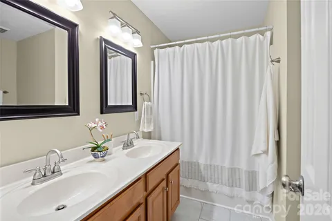 a bathroom with a double vanity sink mirror and