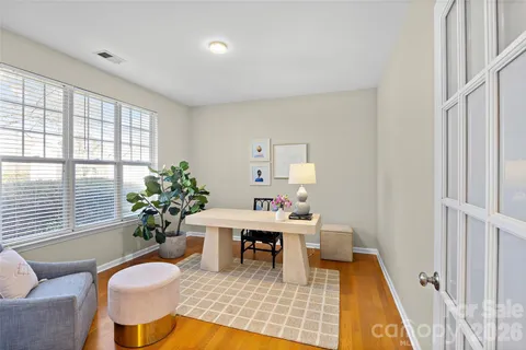 a living room with furniture potted plant and a large window