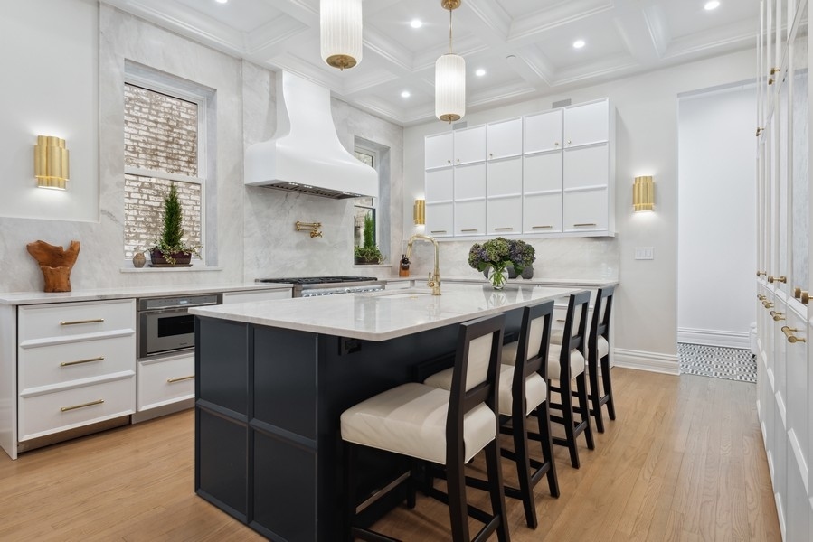 19 East Goethe Street Chicago, IL 60610 - Photo 18 of 46 a kitchen with a table chairs sink and cabinets