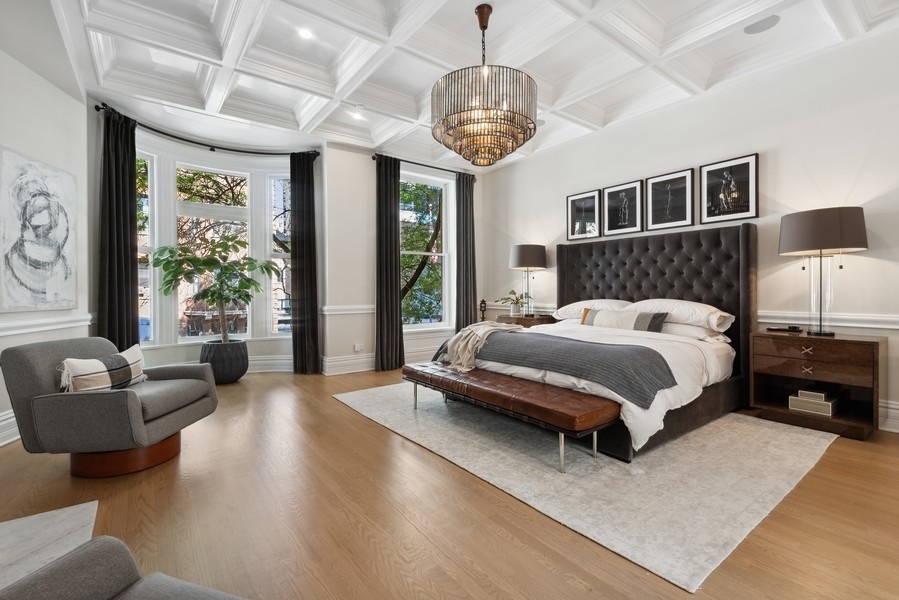 19 East Goethe Street Chicago, IL 60610 - Photo 25 of 46 a spacious bedroom with a bed wooden floor and window