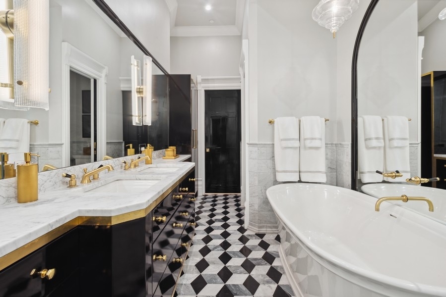 19 East Goethe Street Chicago, IL 60610 - Photo 29 of 46 a bathroom with a granite countertop sink and a bathtub