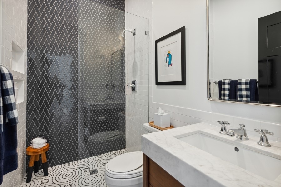 19 East Goethe Street Chicago, IL 60610 - Photo 35 of 46 a bathroom with a toilet a sink and mirror