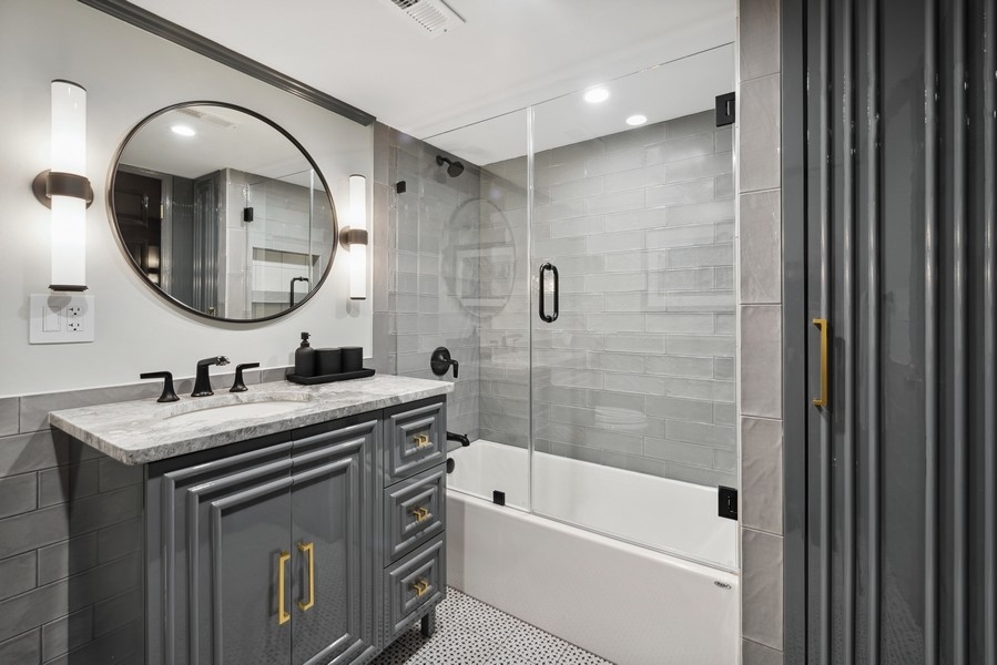 19 East Goethe Street Chicago, IL 60610 - Photo 45 of 46 a bathroom with a tub sink and mirror