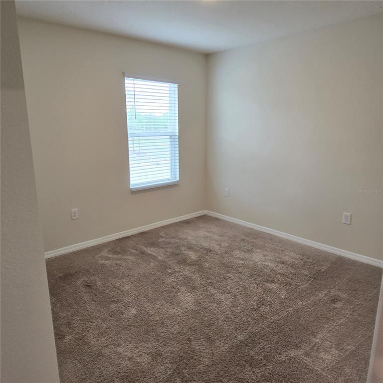 814 Sun Burst Road Winter Haven, FL 33880 - Photo 38 of 48 an empty room with a window