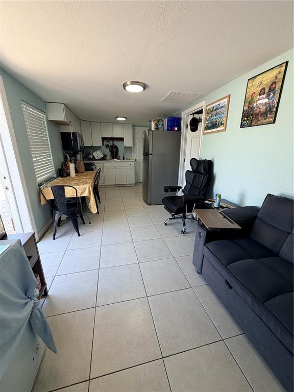 2216 Webber Street, Unit C Sarasota, FL 34239 - Photo 2 of 11 a living room with furniture and a mirror