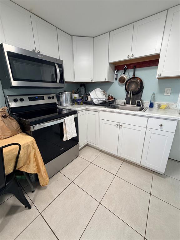 2216 Webber Street, Unit C Sarasota, FL 34239 - Photo 3 of 11 a kitchen with granite countertop a sink and a stove top oven