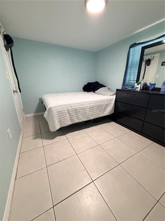 2216 Webber Street, Unit C Sarasota, FL 34239 - Photo 4 of 11 a bedroom with a bed and a mirror