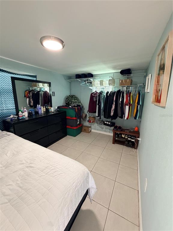 2216 Webber Street, Unit C Sarasota, FL 34239 - Photo 5 of 11 a bed room with a bed and a walk in closet