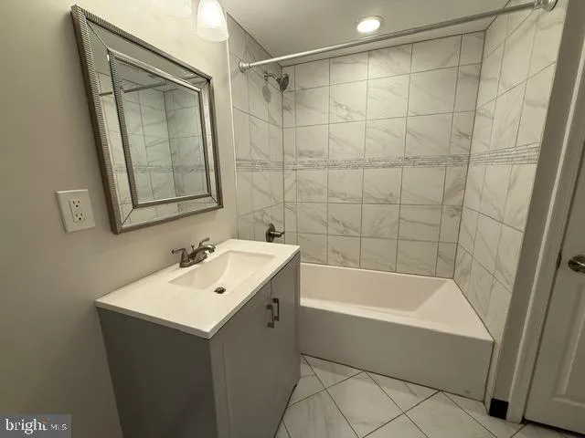 a bathroom with a bathtub and a sink