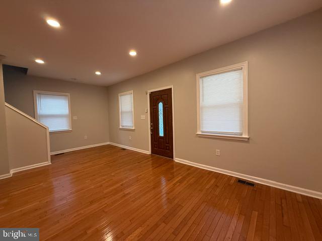 607 St Dunstans Road Baltimore, MD 21212 - Photo 5 of 25 an empty room with wooden floor and windows