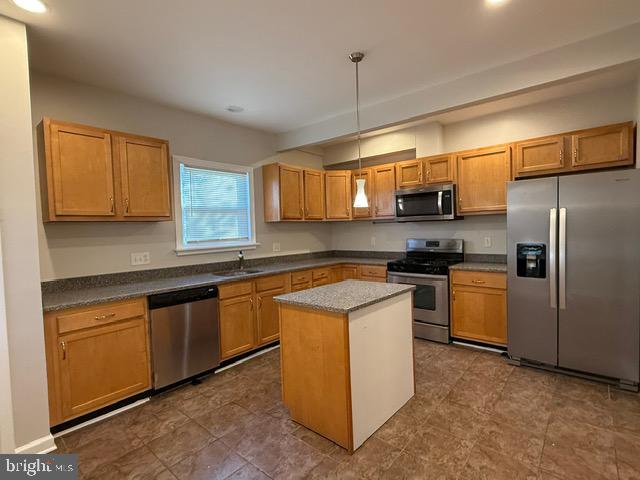 607 St Dunstans Road Baltimore, MD 21212 - Photo 8 of 25 a kitchen with stainless steel appliances granite countertop a stove a sink dishwasher a refrigerator and a microwave