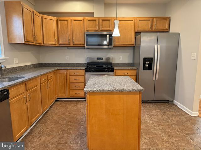 607 St Dunstans Road Baltimore, MD 21212 - Photo 10 of 25 a kitchen with granite countertop wooden cabinets and a refrigerator