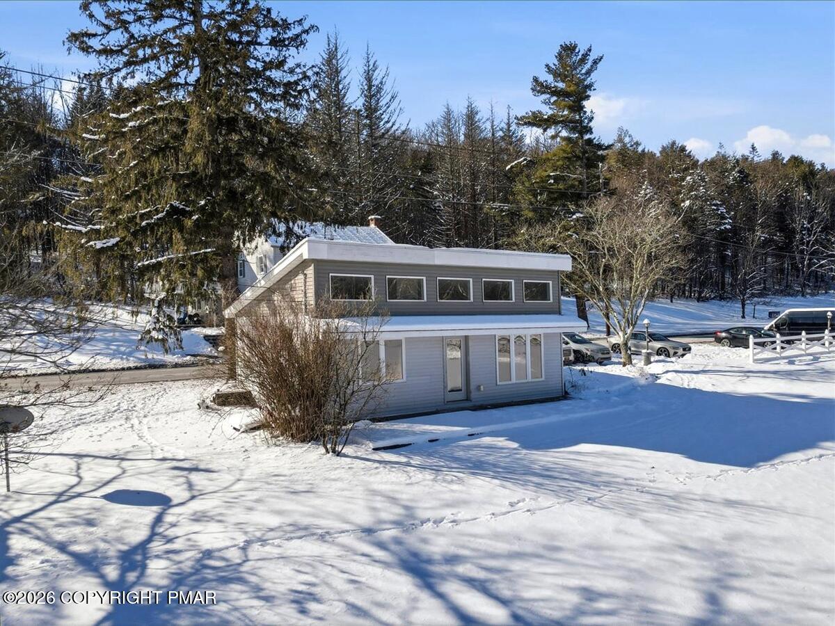 306 Merwinsburg Road Effort, PA 18330 - Photo 29 of 87 a view of a house with a yard covered with snow in the background