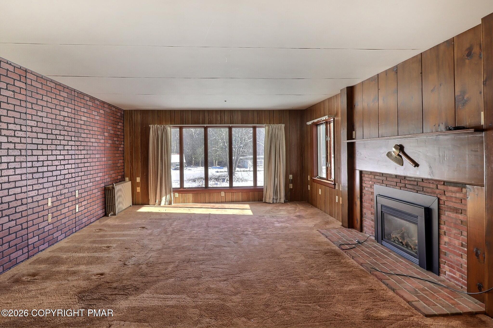 306 Merwinsburg Road Effort, PA 18330 - Photo 41 of 87 a view of an empty room with a fireplace and a window
