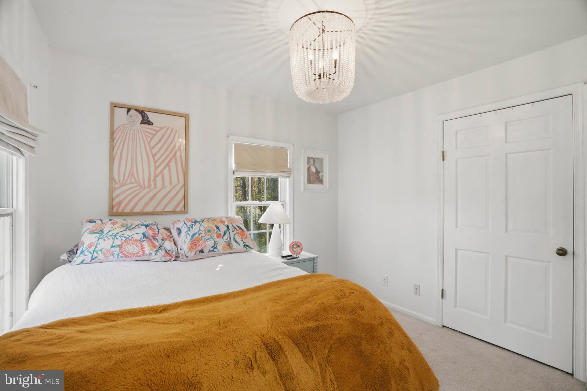 6876 Mink Hollow Road Highland, MD 20777 - Photo 26 of 61 a bedroom with a bed and a chandelier