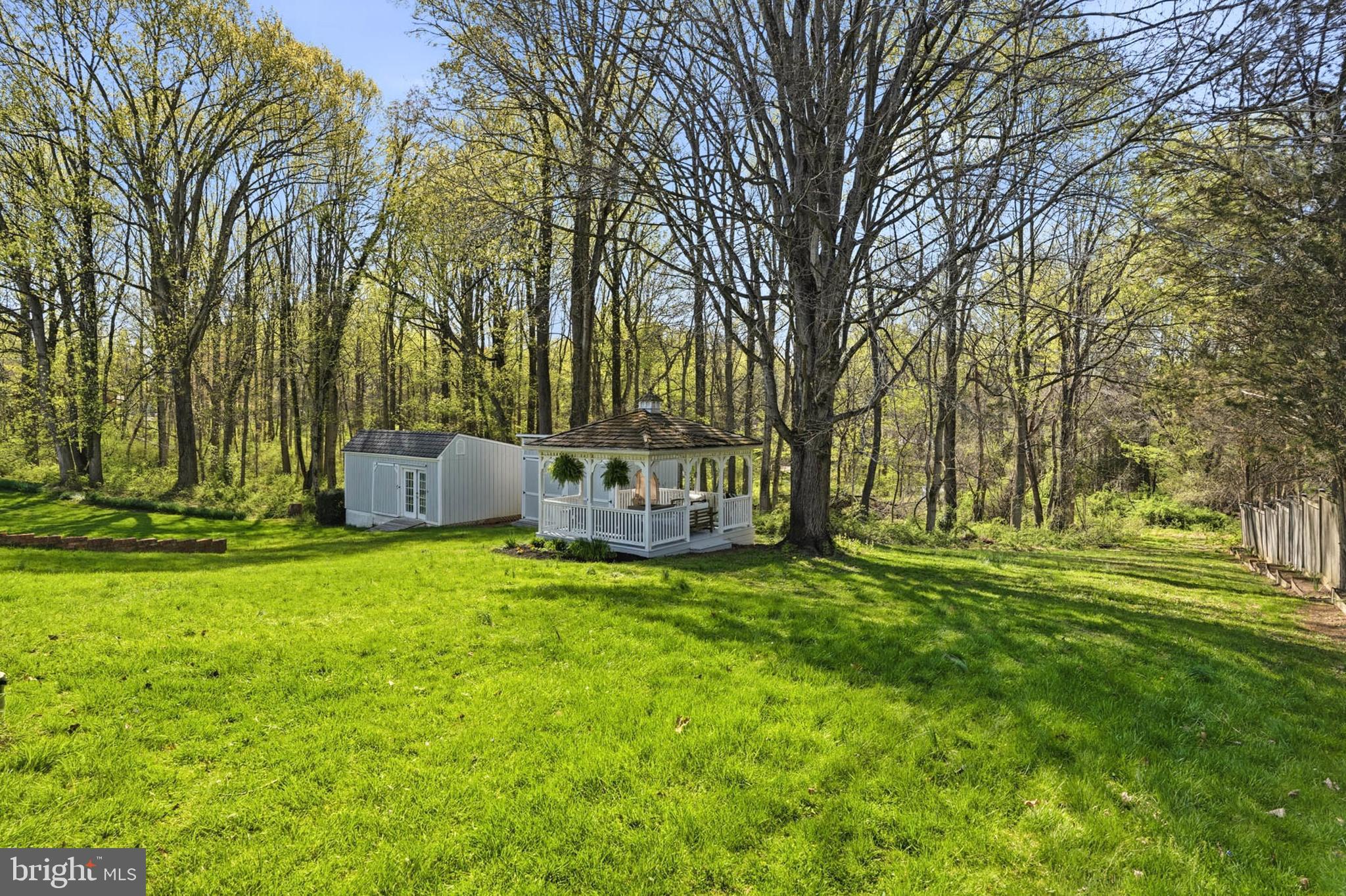 6876 Mink Hollow Road Highland, MD 20777 - Photo 47 of 61 a backyard of a house with table and chairs