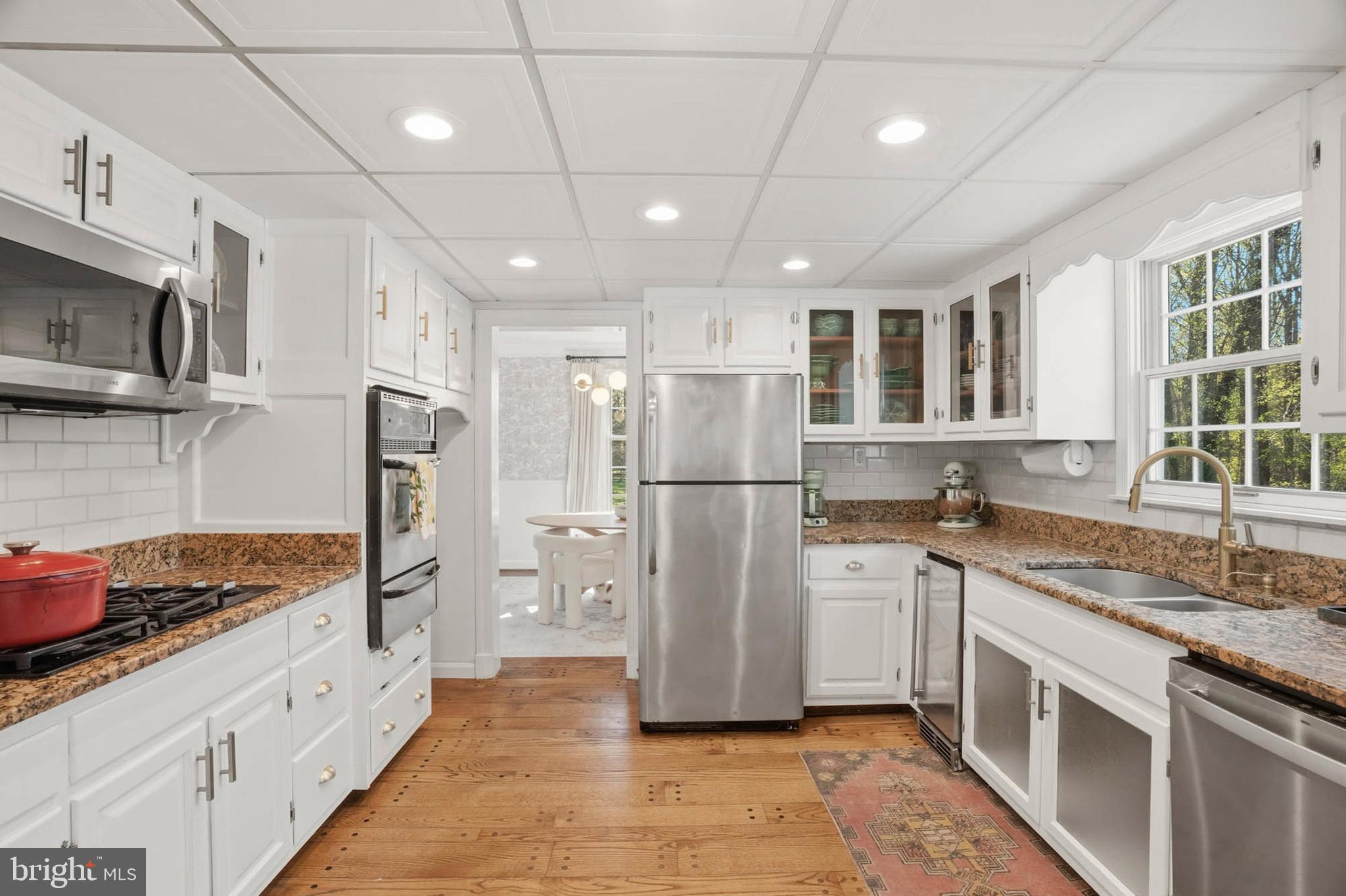 6876 Mink Hollow Road Highland, MD 20777 - Photo 9 of 61 a kitchen with stainless steel appliances granite countertop a refrigerator and a sink