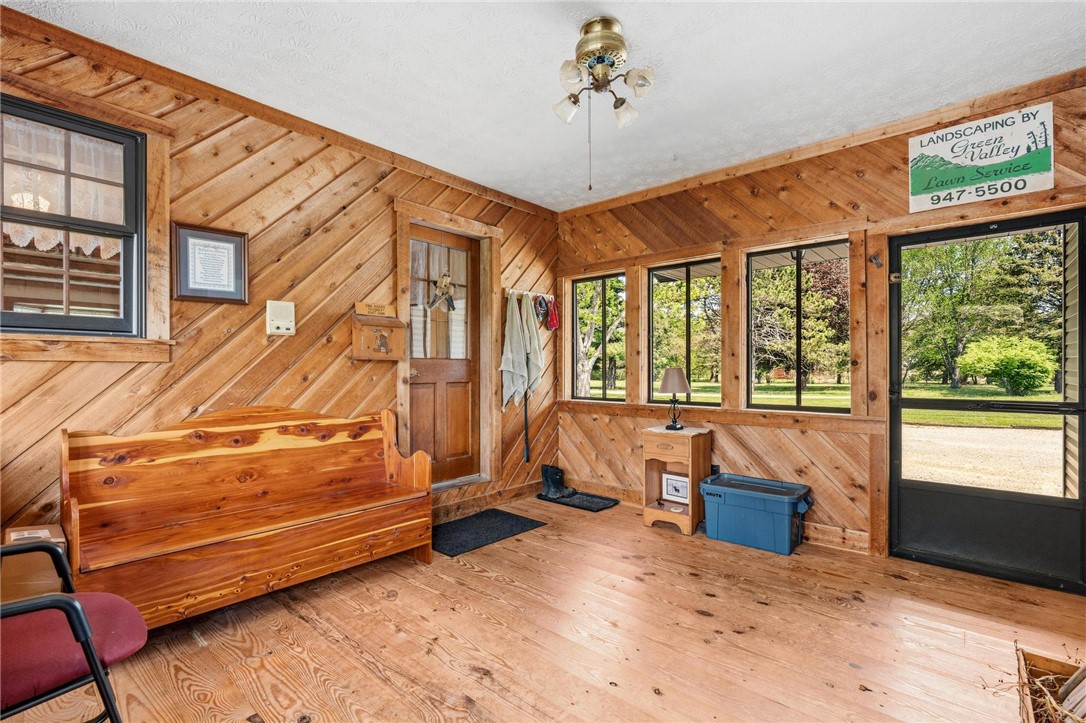 4971 Lackey Road Cedarville, OH 45314 - Photo 43 of 79 This inviting sunroom features abundant natural light and rustic wood paneling, creating a warm, welcoming space.