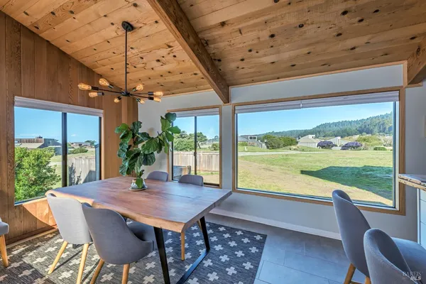 a view of a dining room with furniture window and outside view