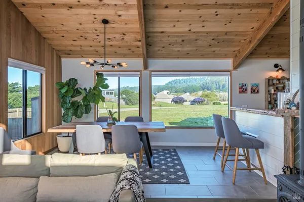 a living room with patio furniture and a floor to ceiling window