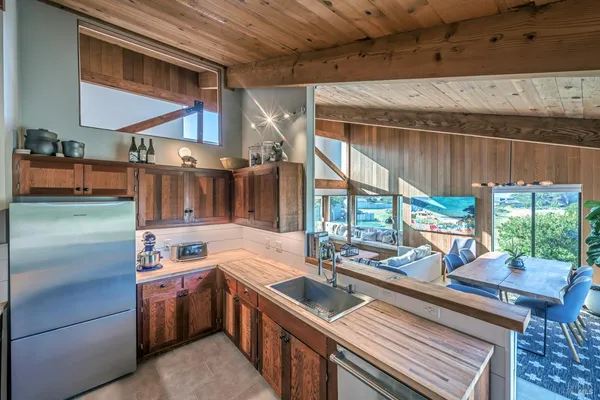 a kitchen with stainless steel appliances granite countertop a sink and a stove
