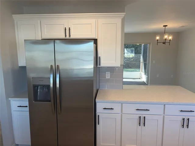 a kitchen with a refrigerator and countertop