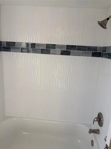 a bathroom with a shower and a bathtub