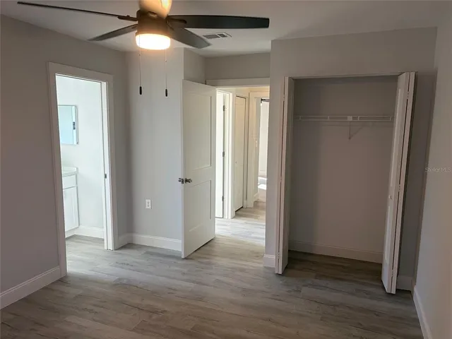a view of a hallway with wooden floor