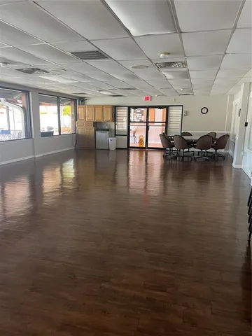 a view of a living room with kitchen countertops and wooden floor