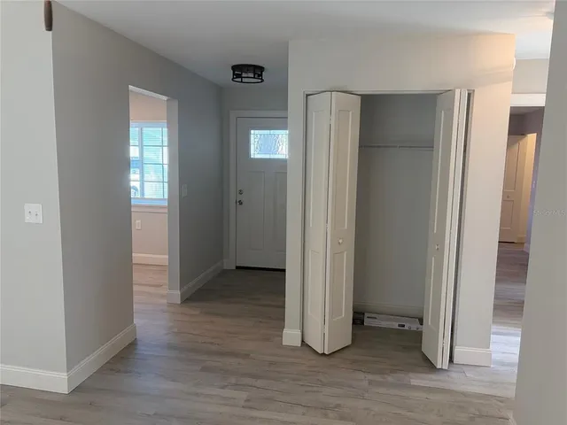 a view of hallway with wooden floor
