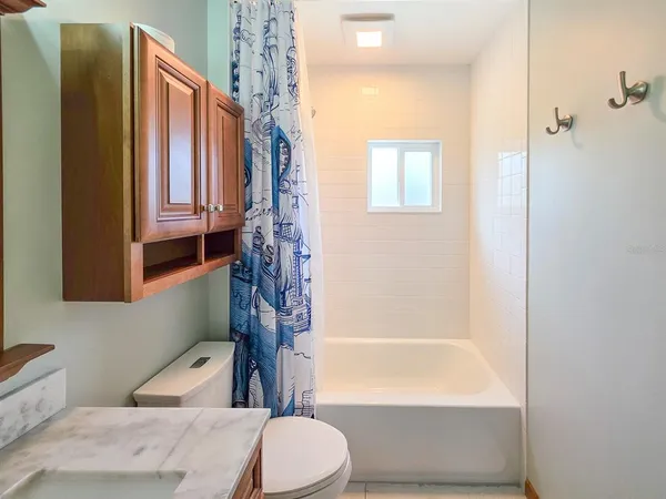 a bathroom with a sink a toilet and mirror