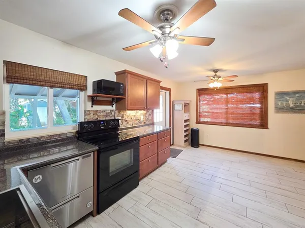 a kitchen with stainless steel appliances granite countertop a stove and a sink