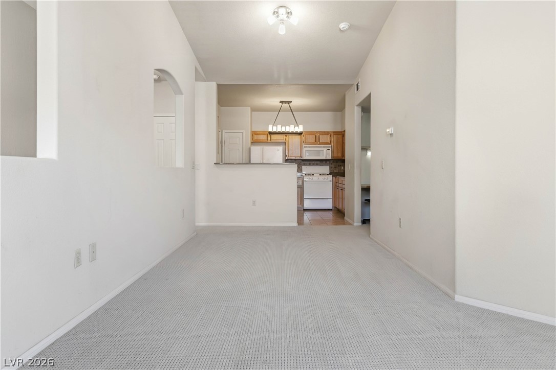 10550 West Alexander Road, Unit 2060 Las Vegas, NV 89129 - Photo 43 of 45 An open floorplan seamlessly connects the living space to a well-appointed kitchen.