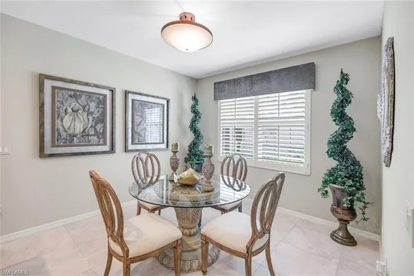 a dining room with furniture and window