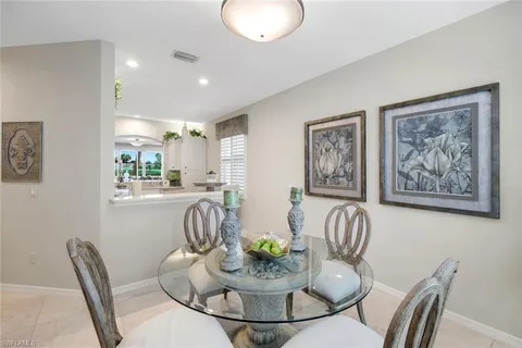 a view of a dining room with furniture and a potted plant