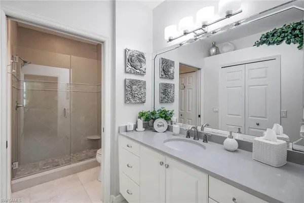 a bathroom with a shower sink and mirror