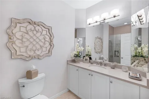 a bathroom with a sink and a mirror with toilet