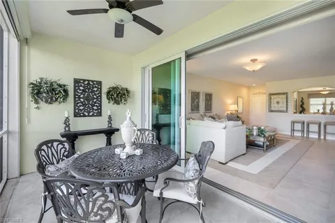 a view of a dining room with furniture and a chandelier